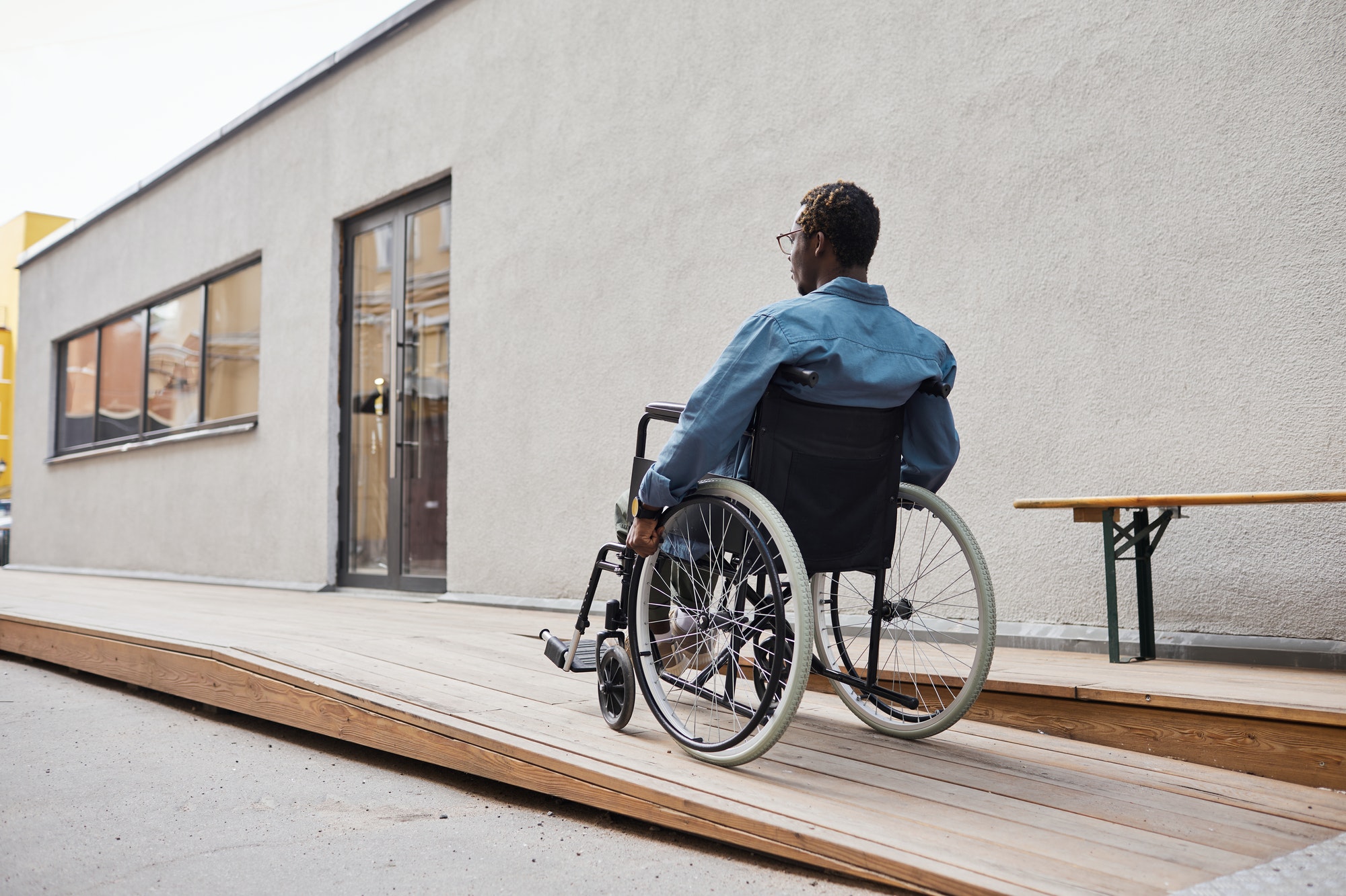 handicapped man using wheelchair ramp
